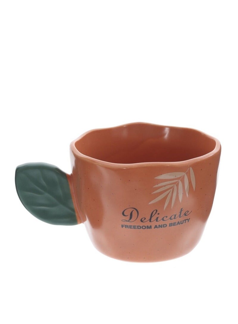 مج بورسيلين راقي سعة 360 ملي باللون البرتقالي التراكوتا مع مقبض مبتكر على شكل ورقة شجر خضراء وتصميم فني لوجه امرأة ونباتات استوائية - Image 4